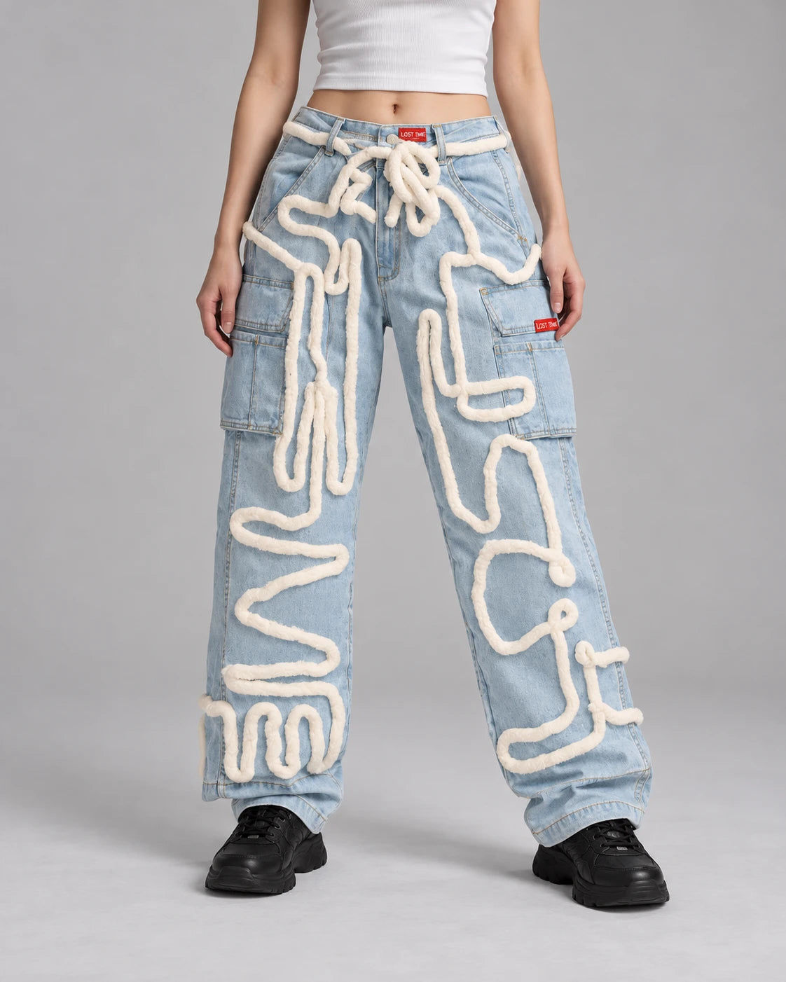 Model wearing BLUE "LOST TIME" SCRIBBLE JEANS