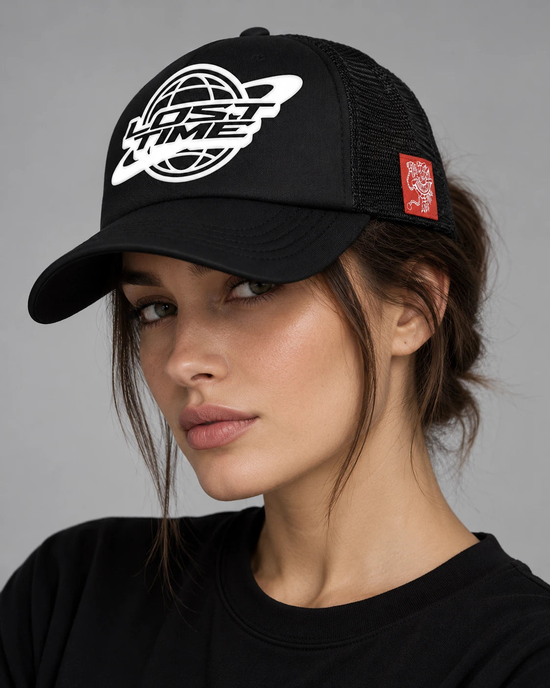 Model wearing "LT WORLDWIDE" TRUCKER HAT
